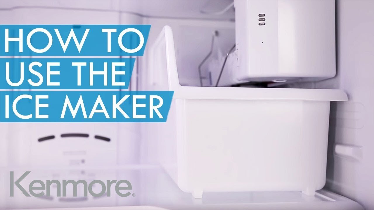 Someone checking a user manual while troubleshooting a refrigerator ice maker.