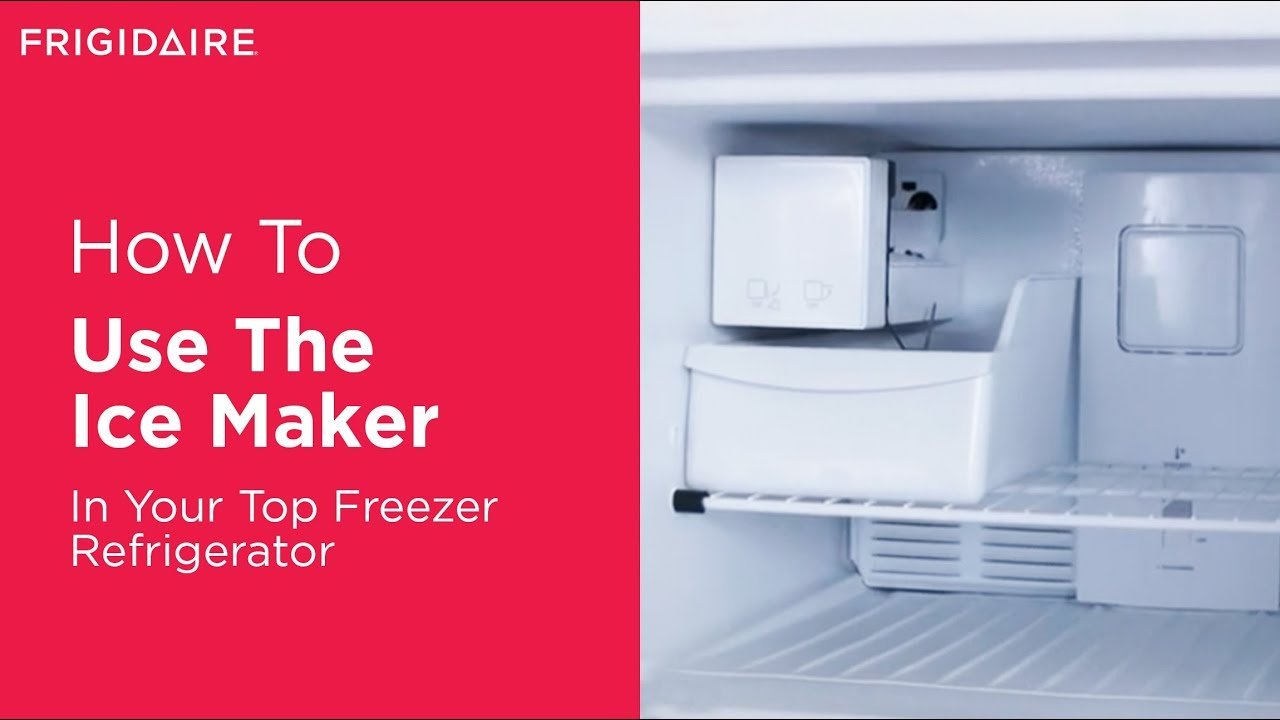 A modern refrigerator freezer filled with fresh ice cubes in a bright kitchen.