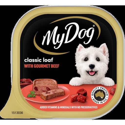 A person carefully reading the ingredient label on a bag of dog food.