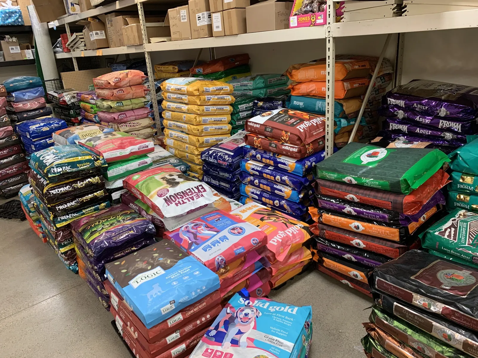 Bulk dog food stacks in restaurant supply warehouse