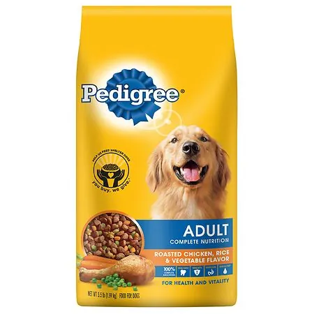 Dog food bags displayed on supermarket shelves while a shopper browses the aisle.