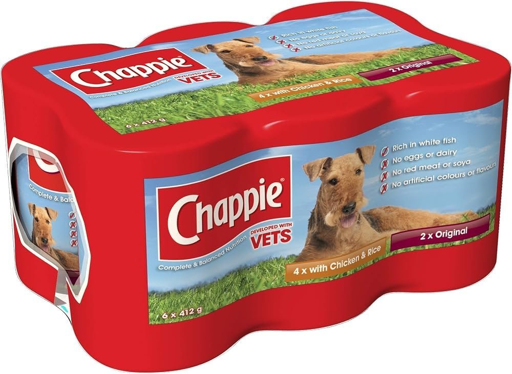 Golden retriever beside Chappie dog food bag on wooden kitchen counter