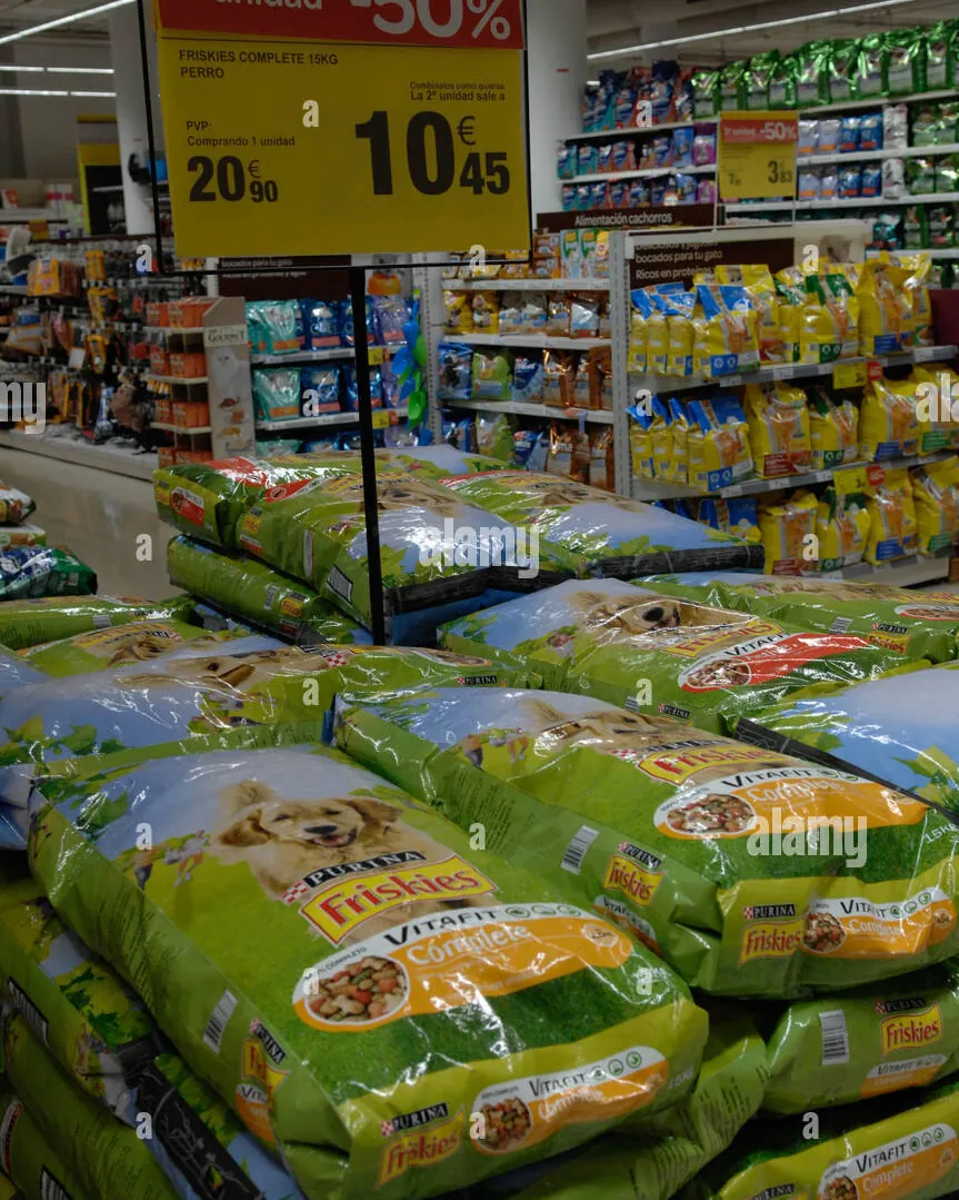 Great Dane standing beside large fifty-pound dog food bag