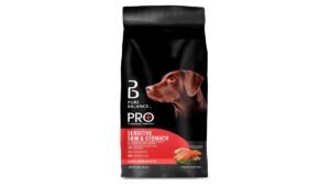 A healthy golden retriever sits in a kitchen next to premium dog food.